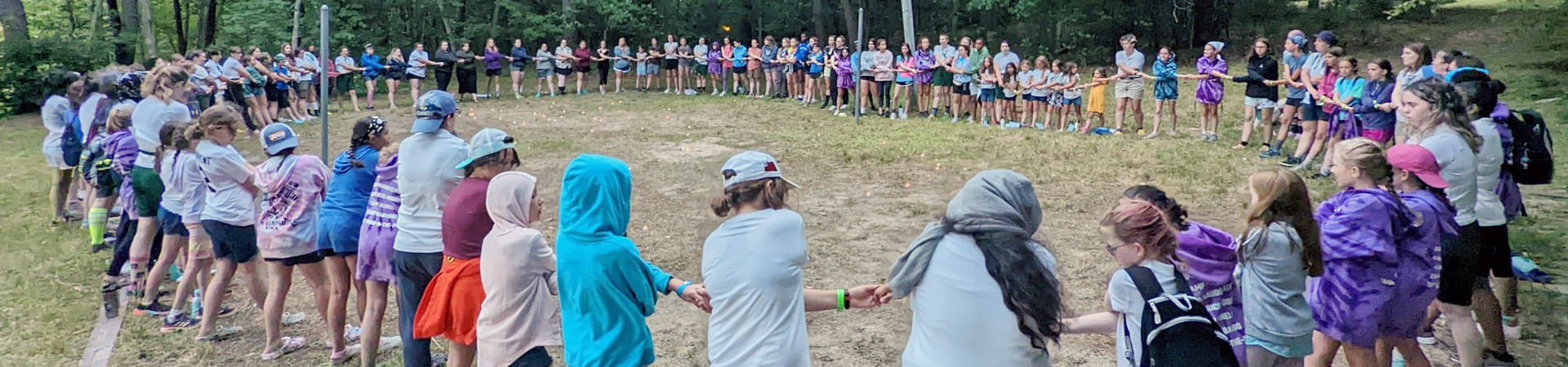  group closing circle at camp of counselors and girls 